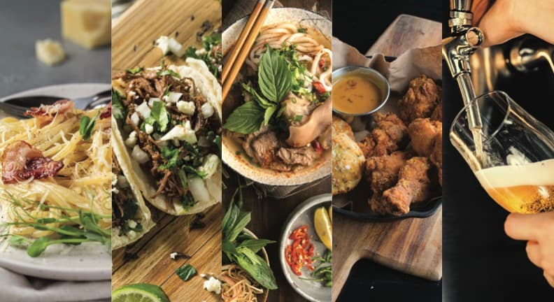 A spread of restaurant dishes — pasta, tacos, pho, fried chicken, and a pour